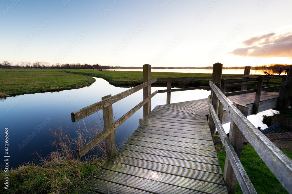 Fototapeta premium wooden bridge through the river