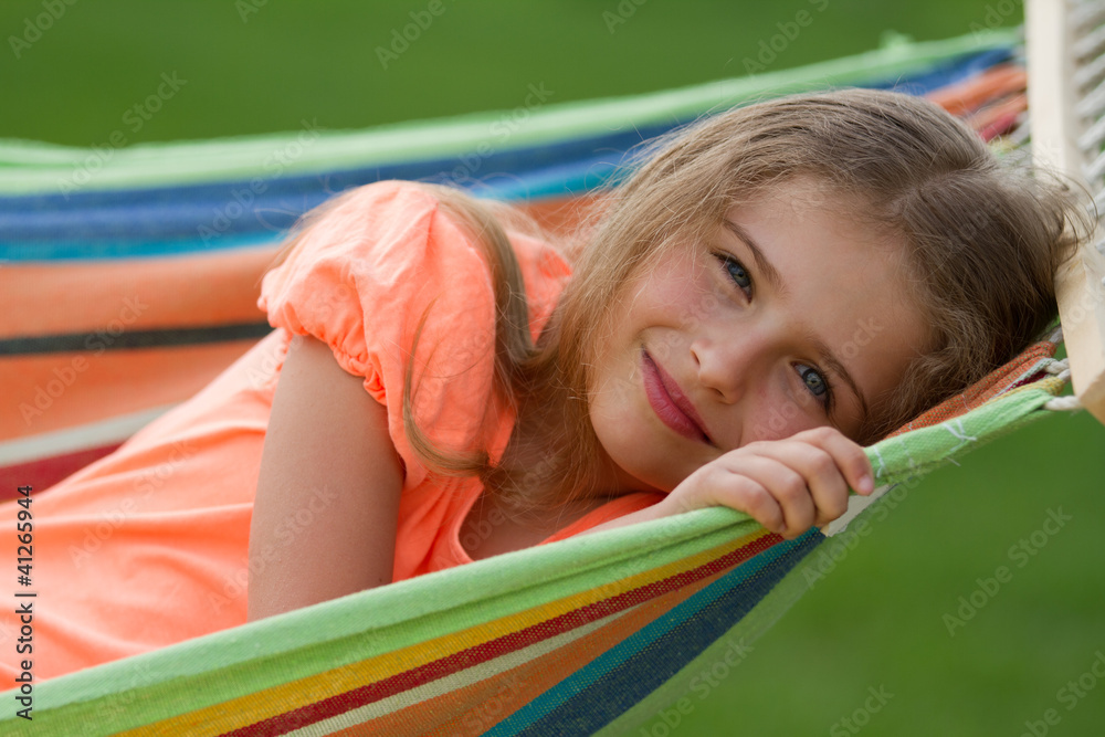 Rest in the garden - lovely girl in colorful hammock Rest in the garden - lovely girl in colorful hammock