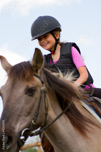 Horse riding - portrait of lovely equestrian on a horse