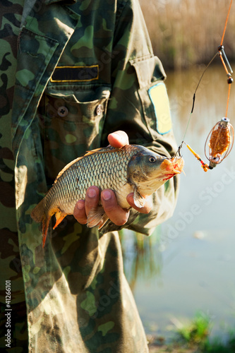 Close-up hands of fisher with the fish