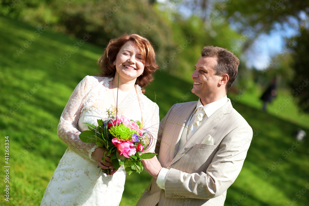 Happy just married couple in park at sunny day