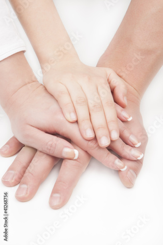 father's, mother's and child's hands together