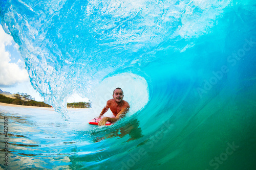Body Boarder on Large Wave Surfing in the Tube Getting Barreled