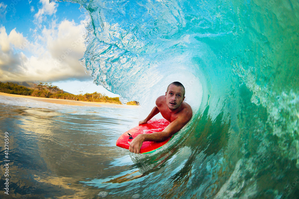 Body Boarder on Large Wave Surfing in the Tube Getting Barreled