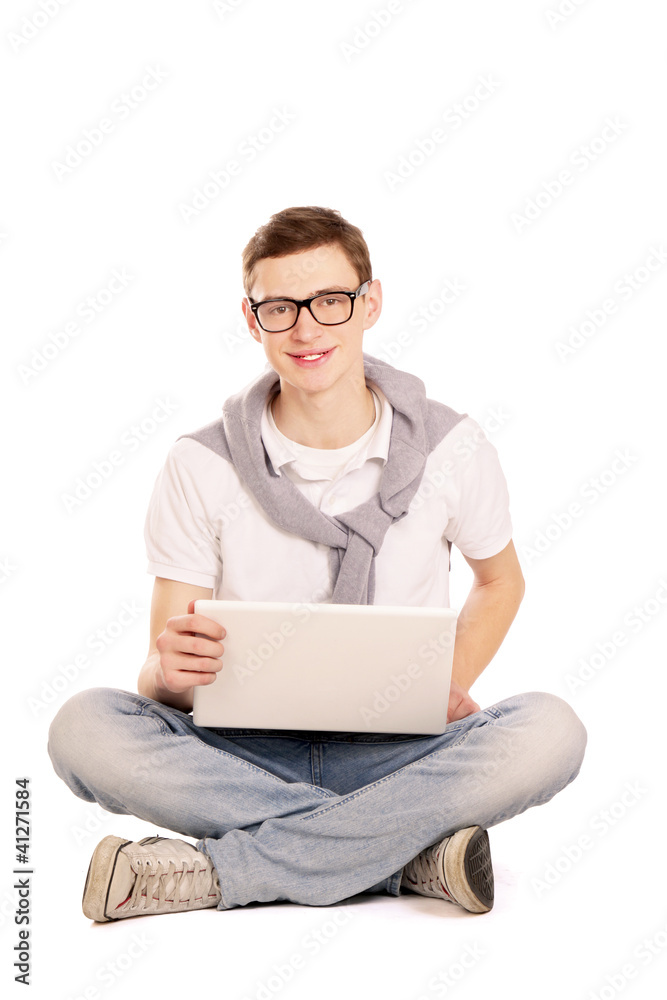 A man working with a laptop sitting on the floor, over white A man working with a laptop sitting on the floor, over white