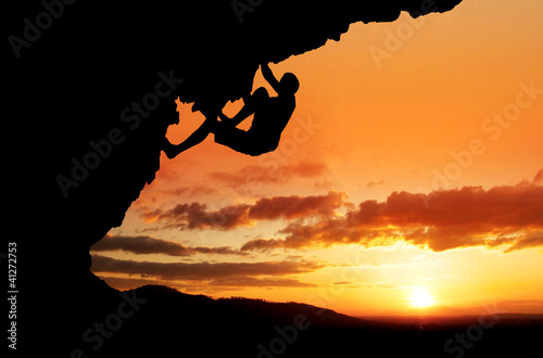 silhouette of free-climber in sunset