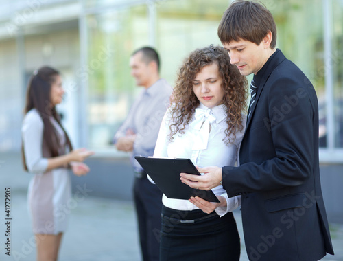 Image of two business partners planning work outdoors