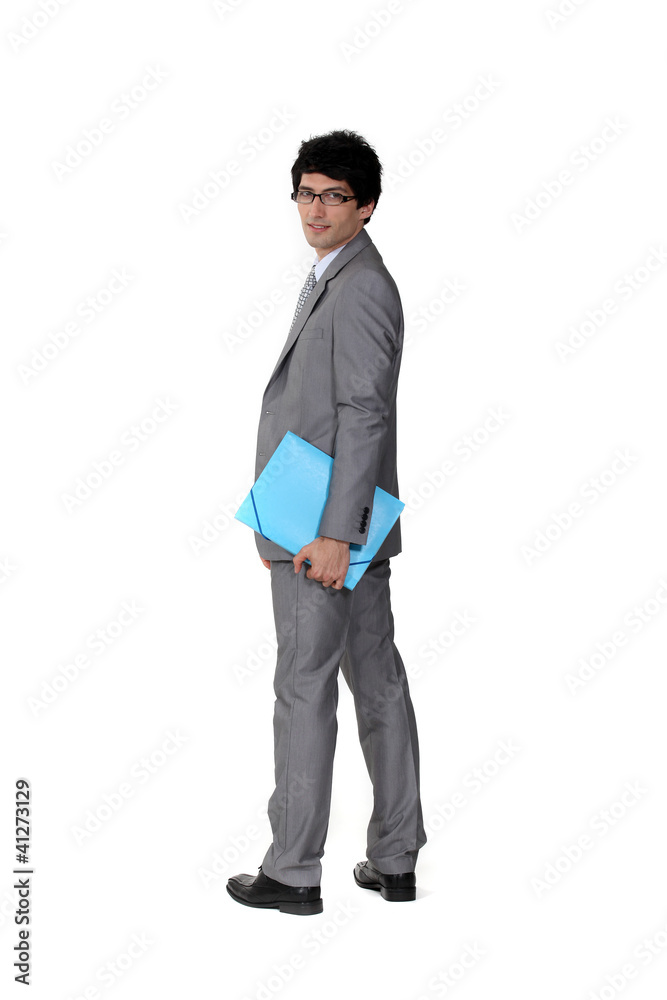 A suave businessman holding a file A suave businessman holding a file