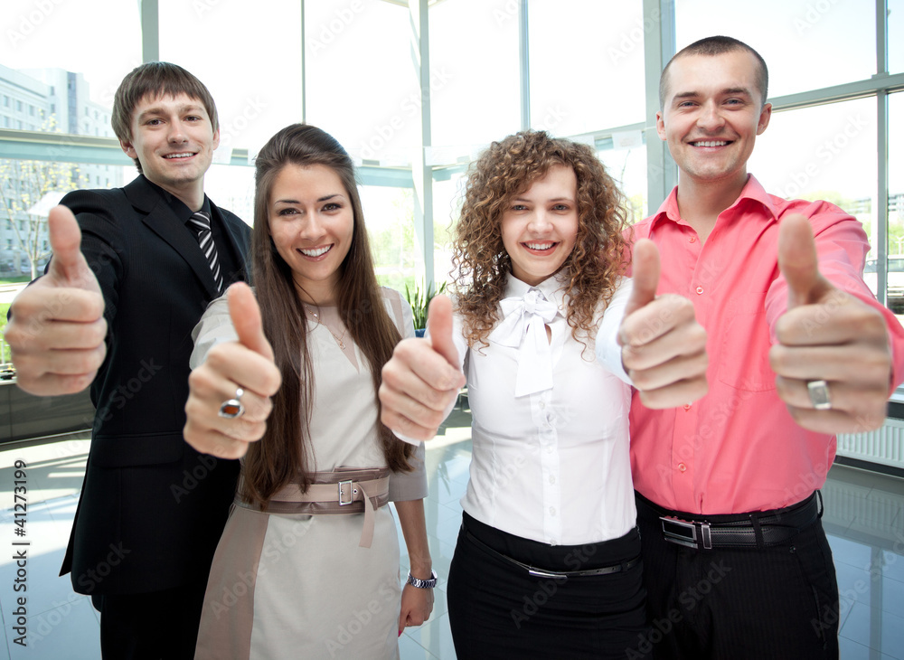 Happy business team with thumbs up in the office
