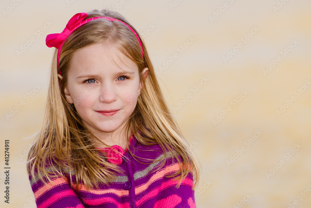 Winter portrait of pretty young girl child wearing knit poncho Winter portrait of pretty young girl child wearing knit poncho