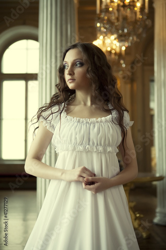 Portrait of a beautiful young victorian lady in white dress