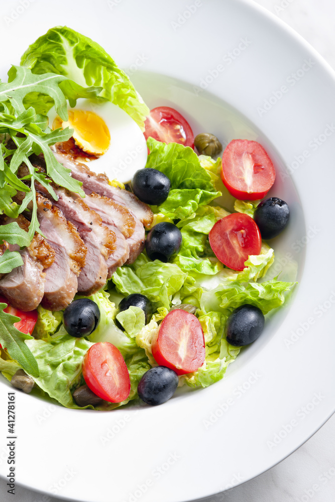 vegetable salad with fried duck breast slices and egg vegetable salad with fried duck breast slices and egg