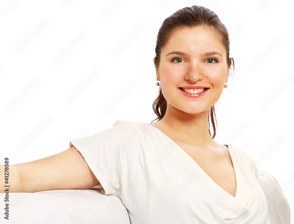Happy young woman sitting on sofa , isolated on white background Happy young woman sitting on sofa , isolated on white background