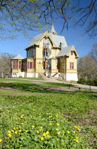 Vertical view for Swedish museum house in spring park