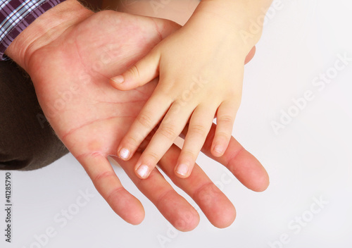 hand of the child in a man s hand