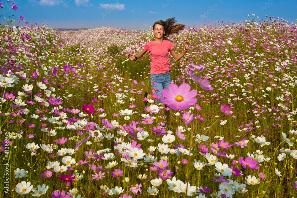 Girl running through field of flowers Stock Photo Adobe Stock