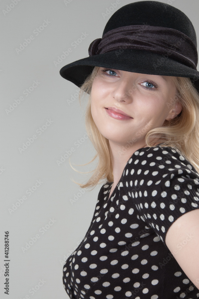 Young beautiful sexy smiling blonde woman in a black hat close-u Young beautiful sexy smiling blonde woman in a black hat close-u
