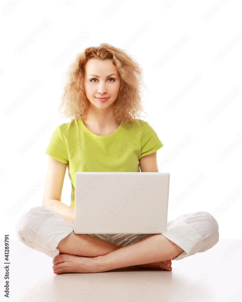 A young girl sitting on the floor with a laptop A young girl sitting on the floor with a laptop