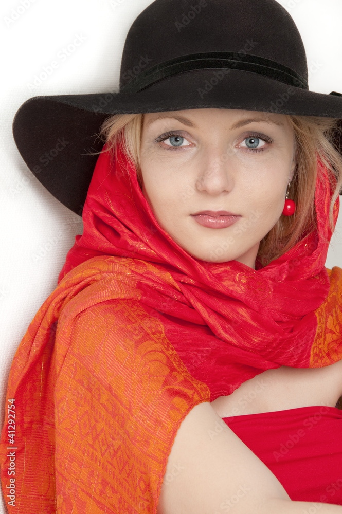 Young beautiful blonde woman in a blsck hat with a red scarf Young beautiful blonde woman in a blsck hat with a red scarf