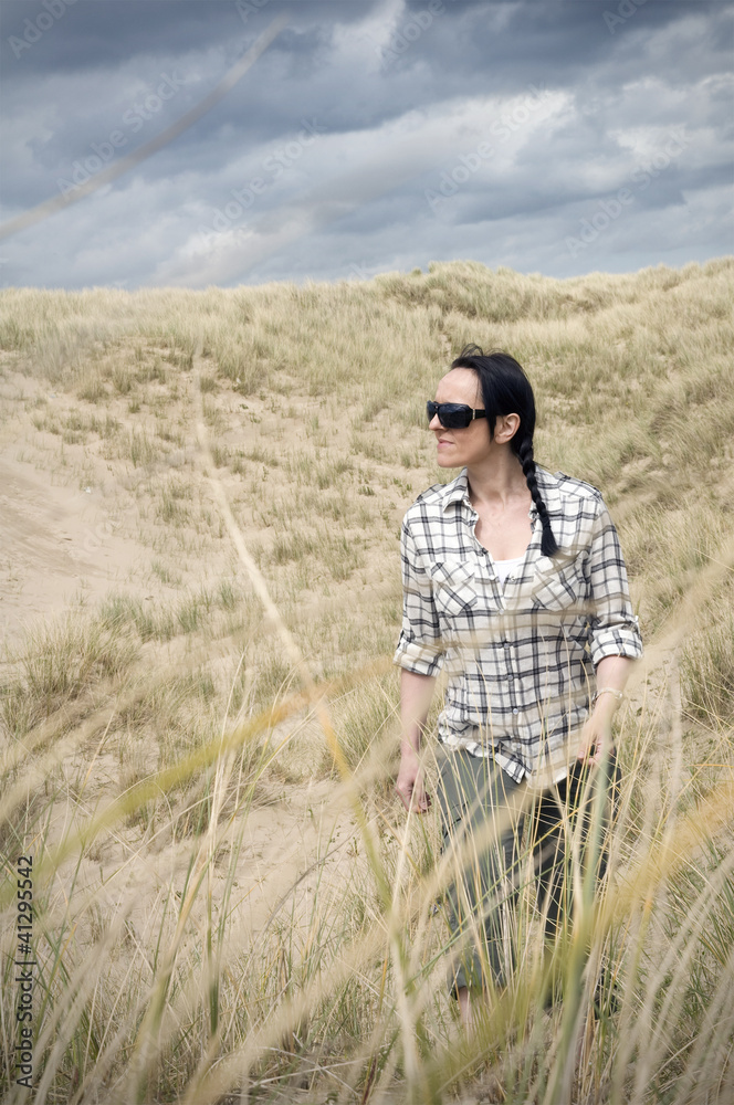 woman walking in sand dunes