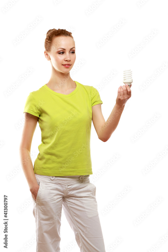 Pensive young woman looking at energy-saving bulb Pensive young woman looking at energy-saving bulb