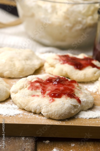 Dough with marmelade on wooden board