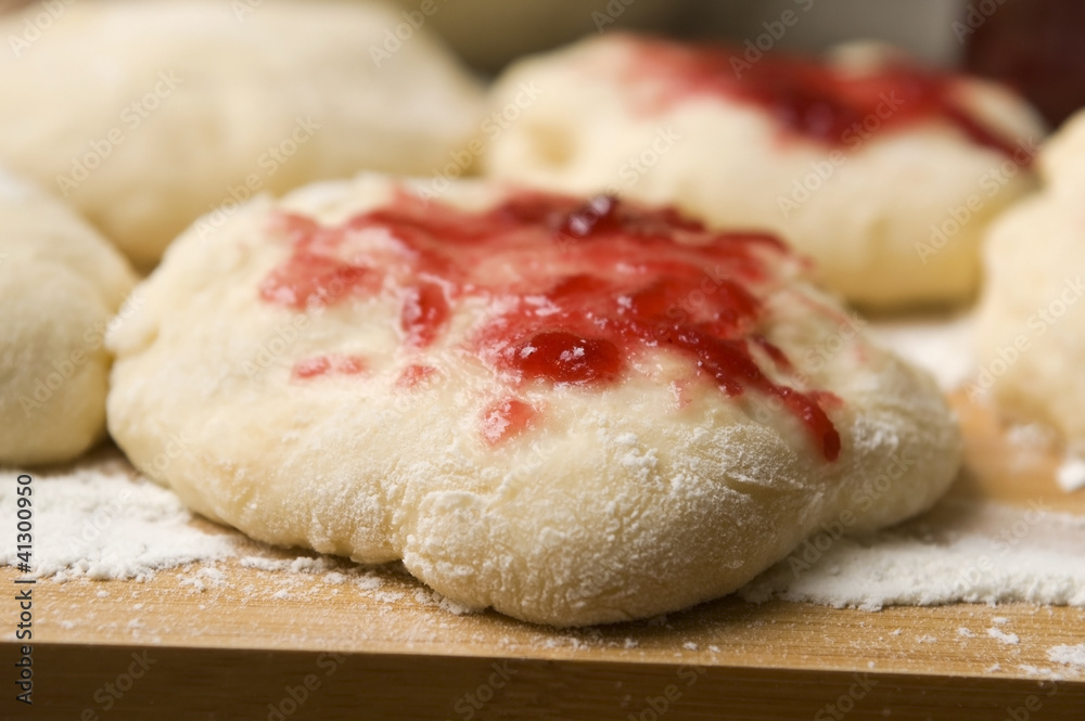 Dough with marmelade on wooden board Dough with marmelade on wooden board