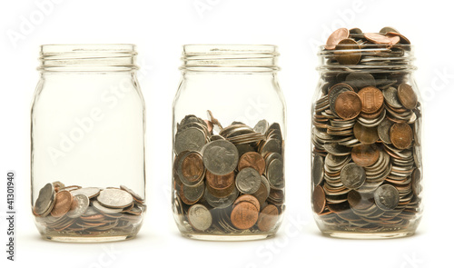 Three glass jars holding coins