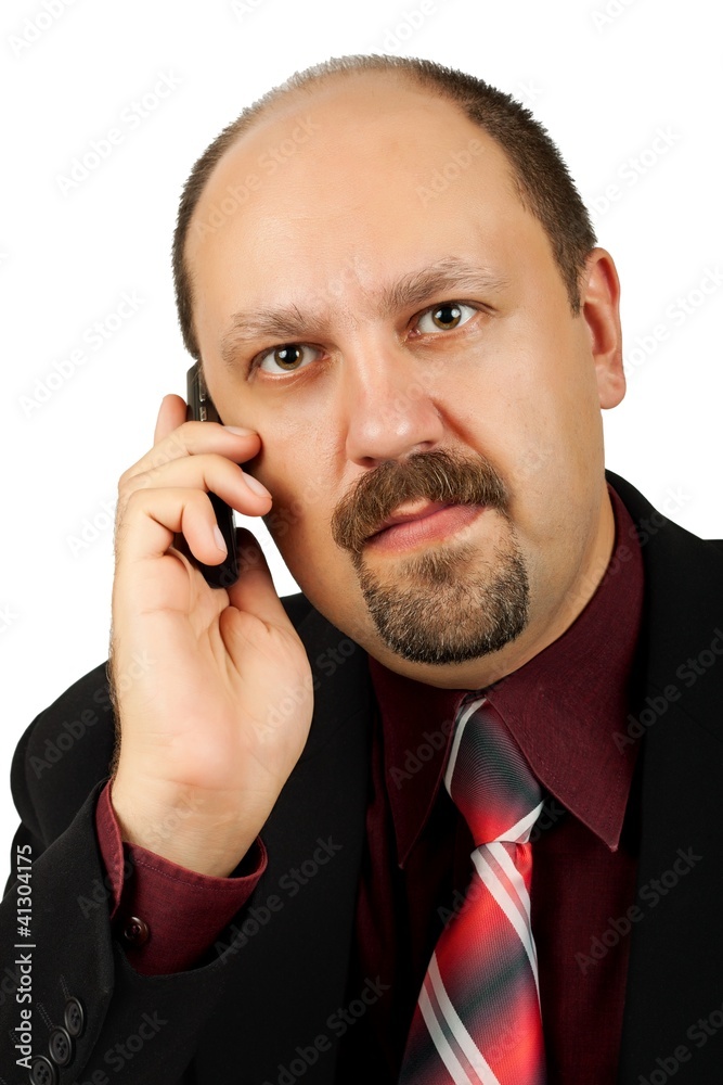Serious businessman talking by mobile phone isolated on white Serious businessman talking by mobile phone isolated on white