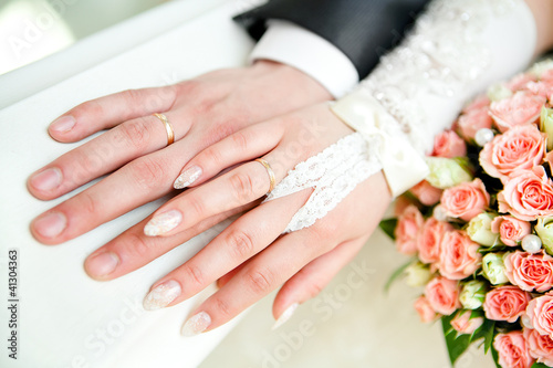 Hands of the groom and the bride with wedding rings