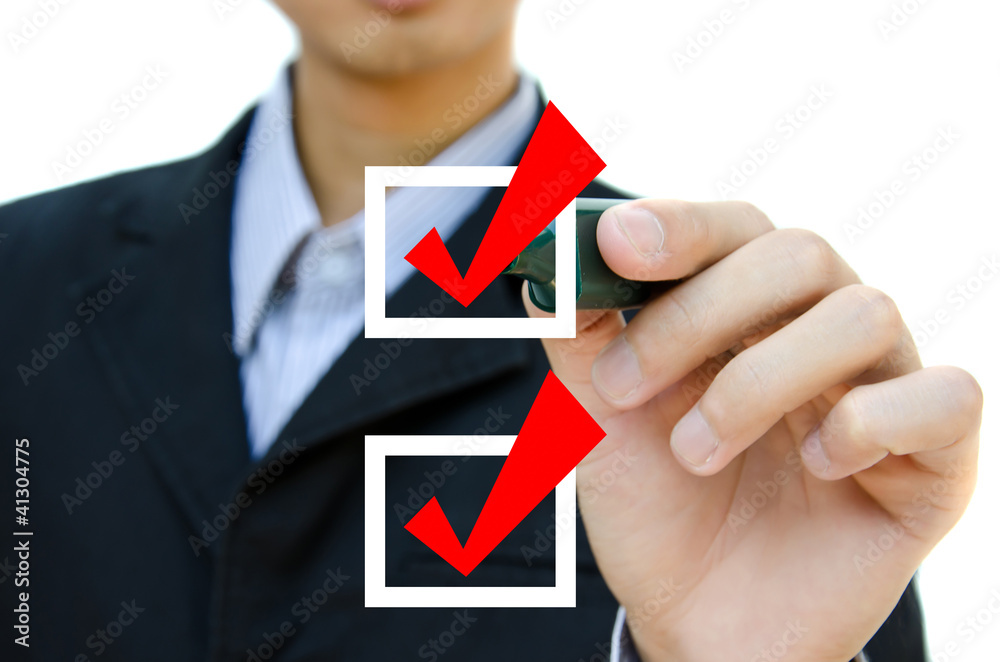 Business hand choosing mark the check boxes of many options. Business hand choosing mark the check boxes of many options.