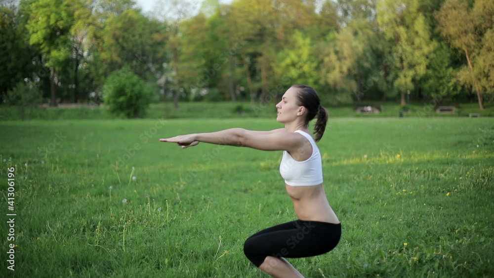 Woman in sport outfit doing a squat exercise Woman in sport outfit doing a squat exercise