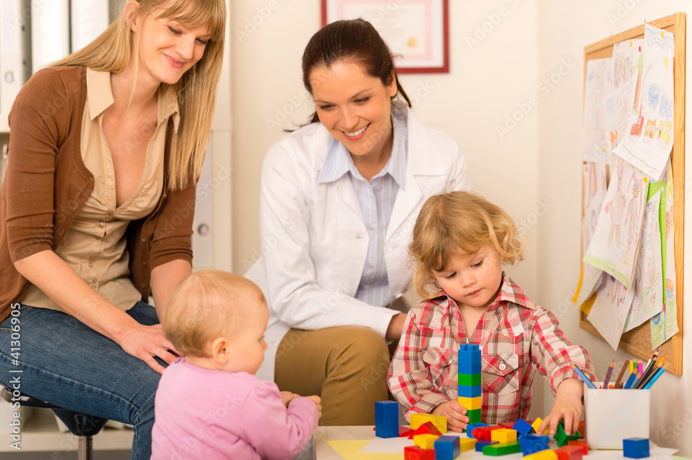 Pediatrician mother daughter playing at office Pediatrician mother daughter playing at office