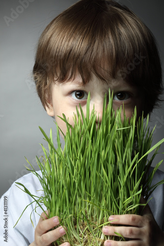 boy with grass, studio shot