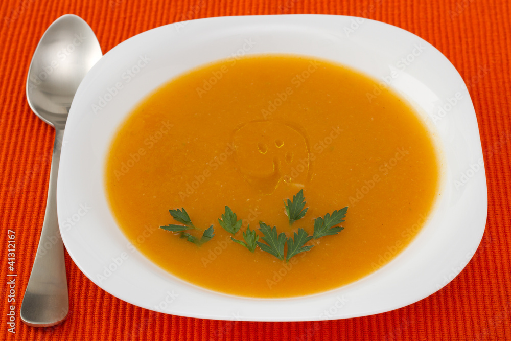pumpkin soup with parsley in white plate pumpkin soup with parsley in white plate