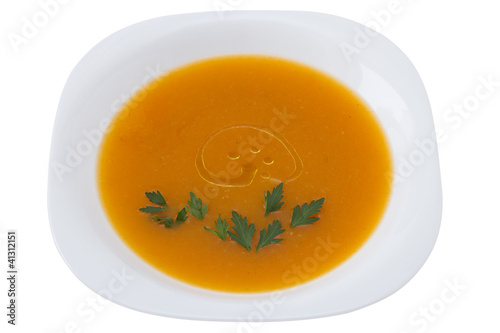 pumpkin soup with parsley in white plate