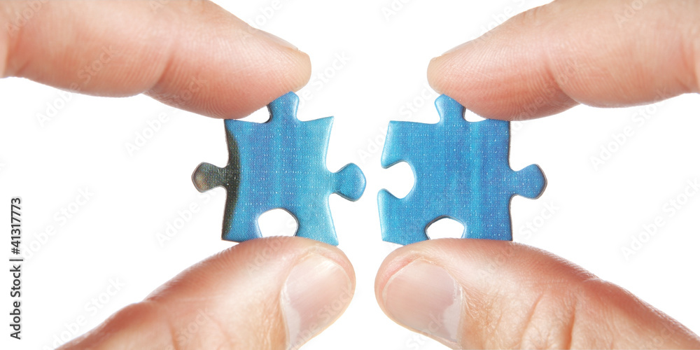 Connecting two puzzles. On a white background. Connecting two puzzles. On a white background.