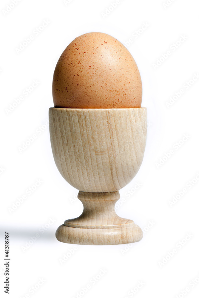 Egg isolated on white background over a typical wood port egg Egg isolated on white background over a typical wood port egg