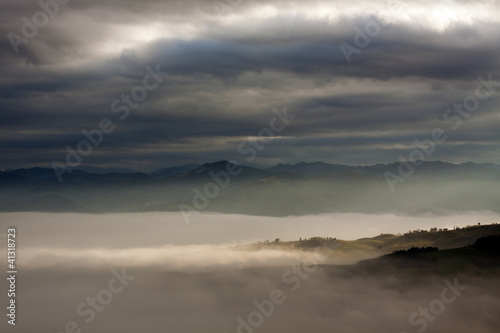 Wind Valley in Romagna (Italy) under the clouds, foggy with a sunshine