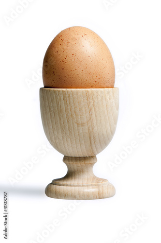 Egg isolated on white background over a typical wood port egg