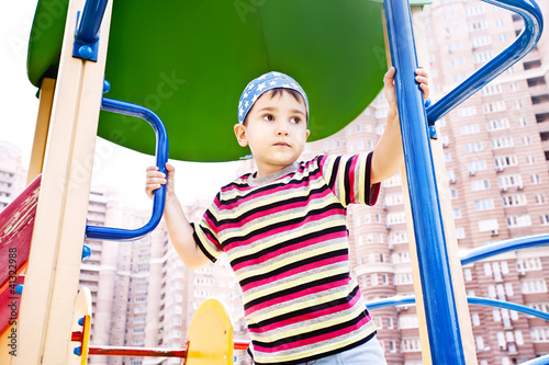 Young boy in bandana on playground photo