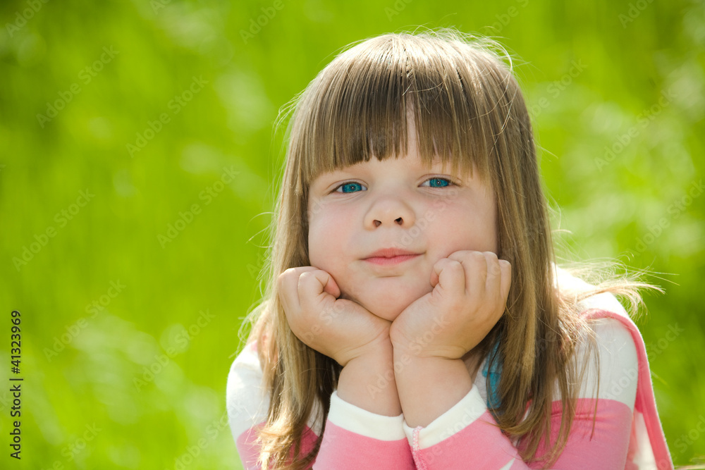 little girl wearing pink blouse on green summer grass little girl wearing pink blouse on green summer grass