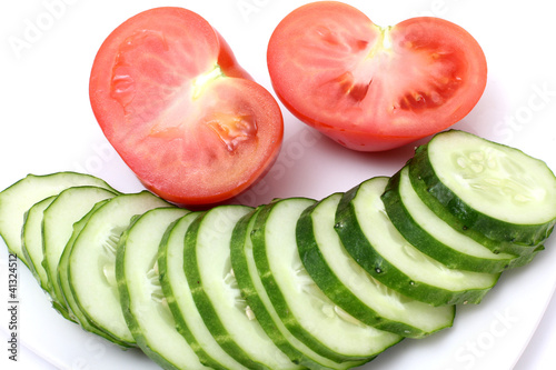 Tomatos and cucumber on plate