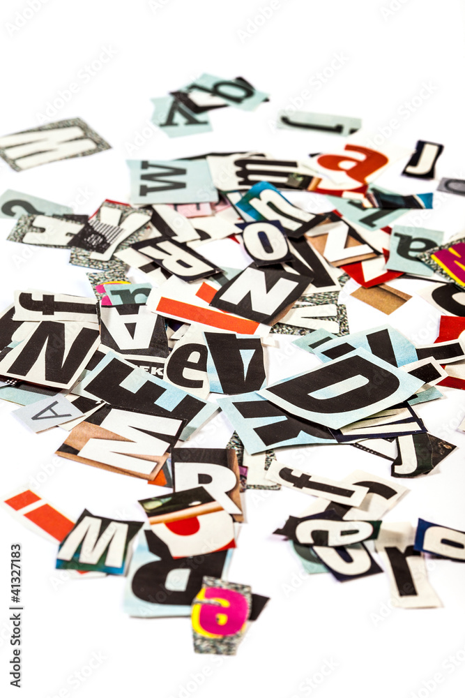 Scattered cut out letters on white background