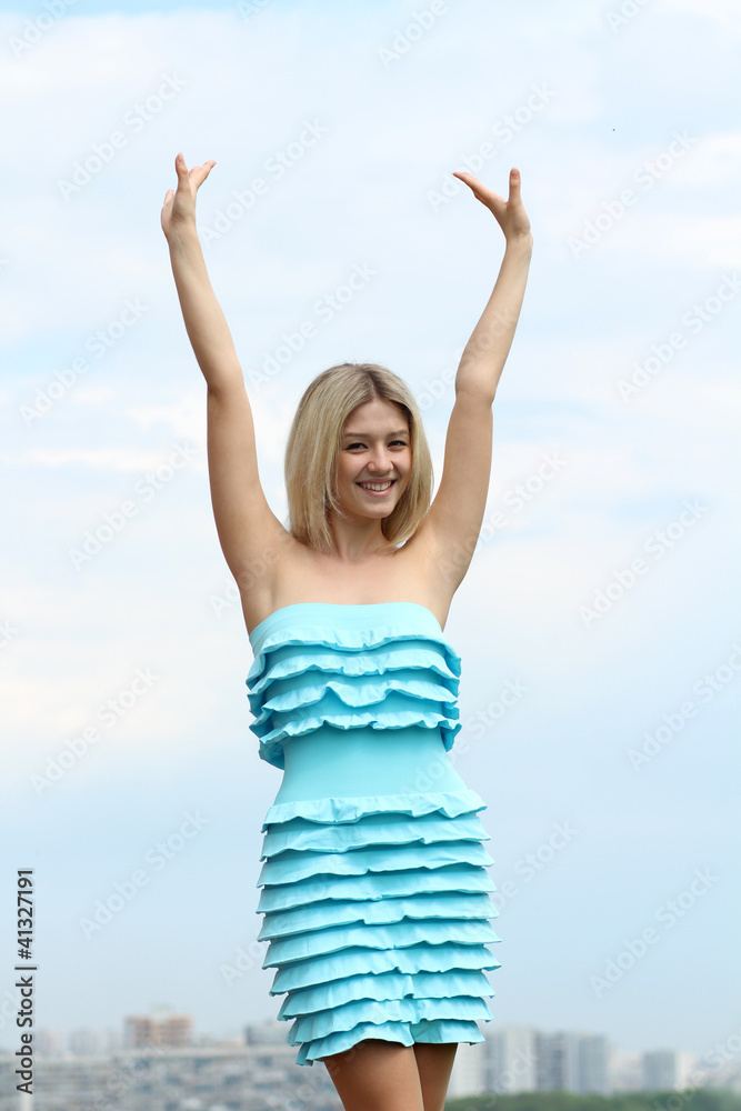 Young blond woman in sexy dress on background of the sky Young blond woman in sexy dress on background of the sky