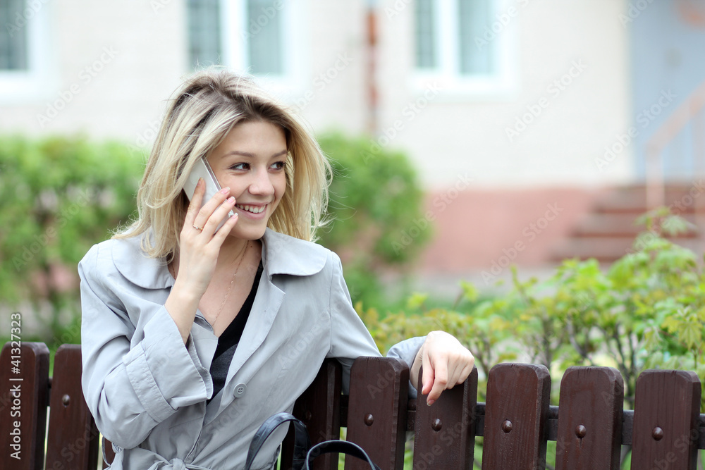 Fototapeta premium portrait of young woman talking on mobile phone