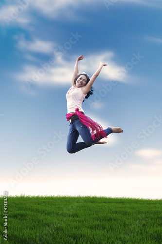 Excited Asian woman jumping