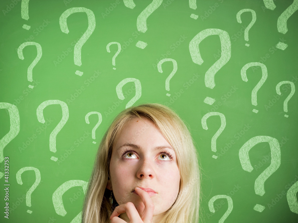 Thinking woman in front of blackboard with question marks Thinking woman in front of blackboard with question marks