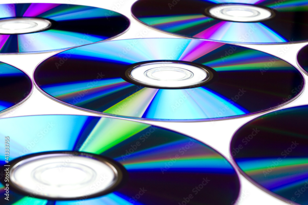 Pattern of cd/dvd disks over white Pattern of cd/dvd disks over white