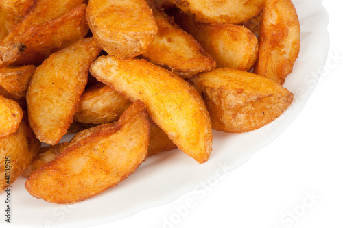 Fried potato wedges isolated on white background